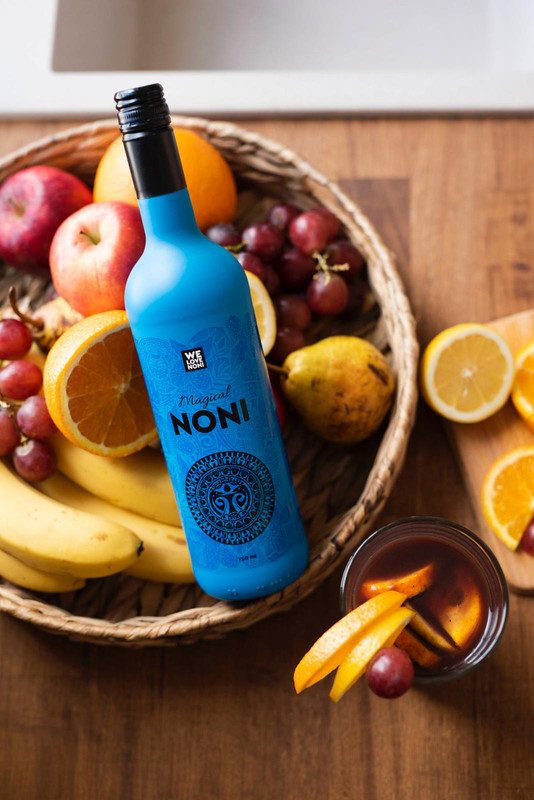 pouring a daily measure of noni juice